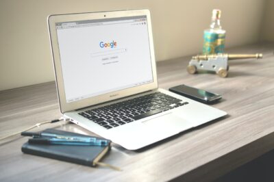 An open laptop computer sitting on top of a table